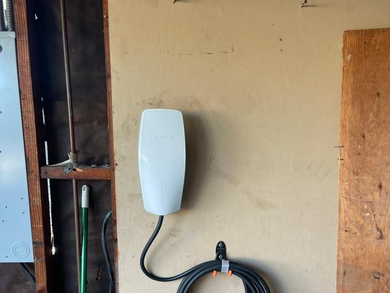 Wall-mounted EV charger installed in a garage