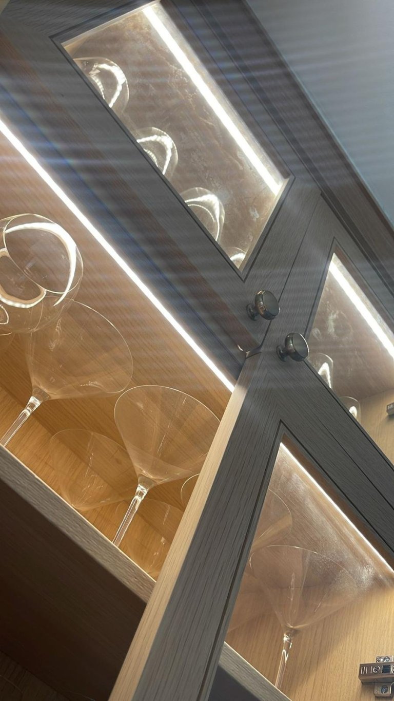 LED lighting in a glass cabinet with stemware